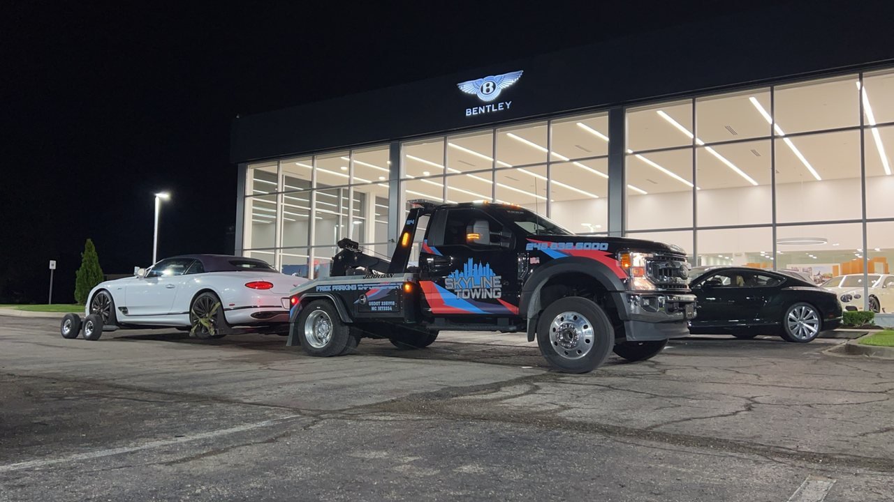 Luxury convertible on wheel dollies at a dealership